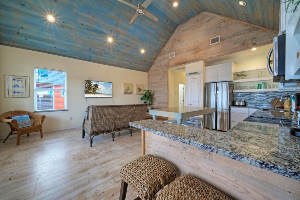 Kitchen features a counter with barstool seating.