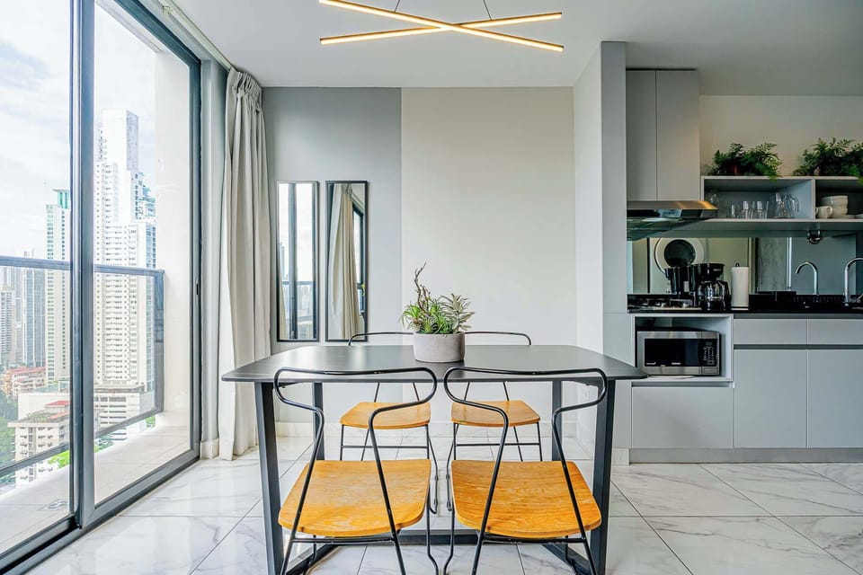 Dining area surrounded by natural light and city views.