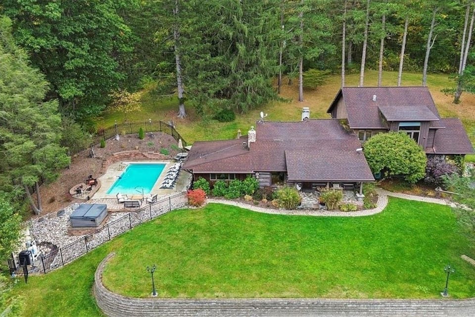Escape to our classic log cabin woodland retreat featuring a private outdoor pool and hot tub, nestled within the tranquil embrace of towering pines. Enjoy maximum privacy on our secluded lot. 