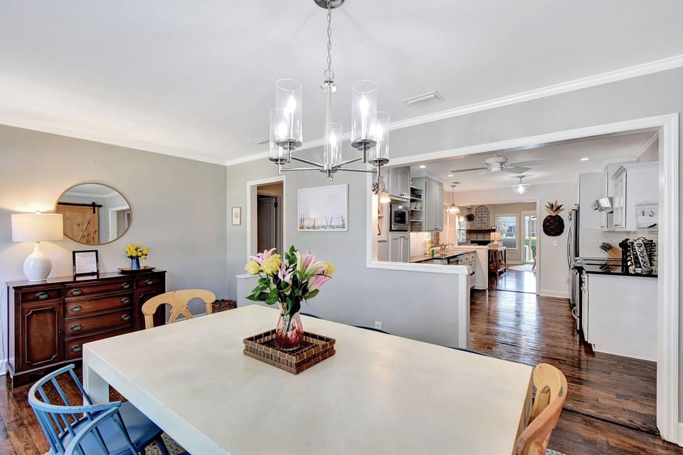 Dining Room with Open Kitchen View – Beach Crew Cottage - With seating for eight and a direct line to the main kitchen, this open dining space is perfect for family meals, card games, or a round of cocktails before dinner out in the Village. Bonus: the wooden coffee bar is just around the corner.