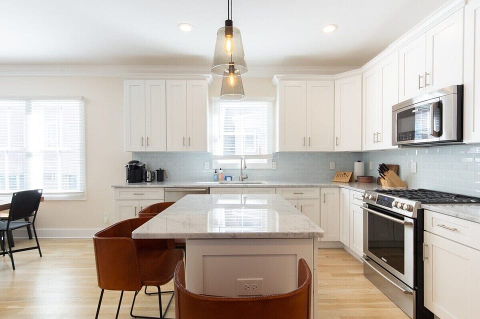Kitchen - Whip up a delicious meal in our fully-equipped, chef-ready kitchen, featuring brand-new stainless steel appliances and a spacious marble-top island for easy food preparation. 