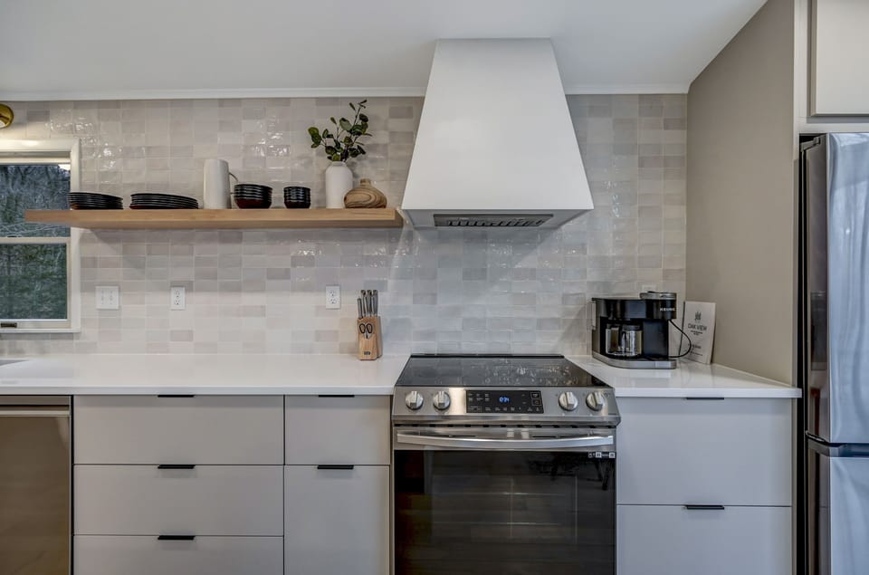 Gorgeous tile backsplash brings visual interest to the space and 