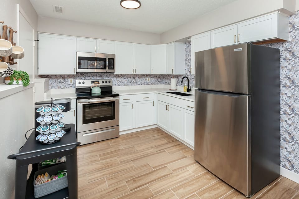 Brand new stainless steel appliances and coffee bar in kitchen. 