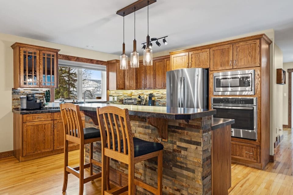 Full kitchen, located on the main floor, with an island and dedicated dining area.