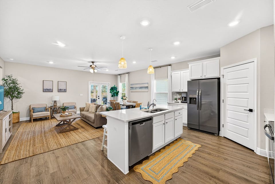 Settle into your spacious open-concept living area, where your modern kitchen flows seamlessly into a cozy lounge with natural light, perfect for gathering after a day of exploring.
