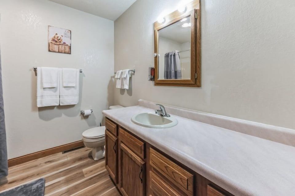 Experience functionality and style in our bathroom, equipped with a sleek sink set in expansive countertops. The generous space ensures ample room for your toiletries, allowing you to easily prepare for the day or unwind for the evening in an uncluttered setting.