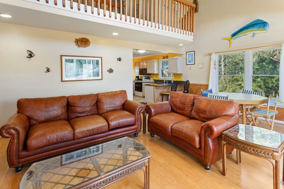 Relax in the Mid-Level Living Area with comfortable furniture and a large, flat screen TV!