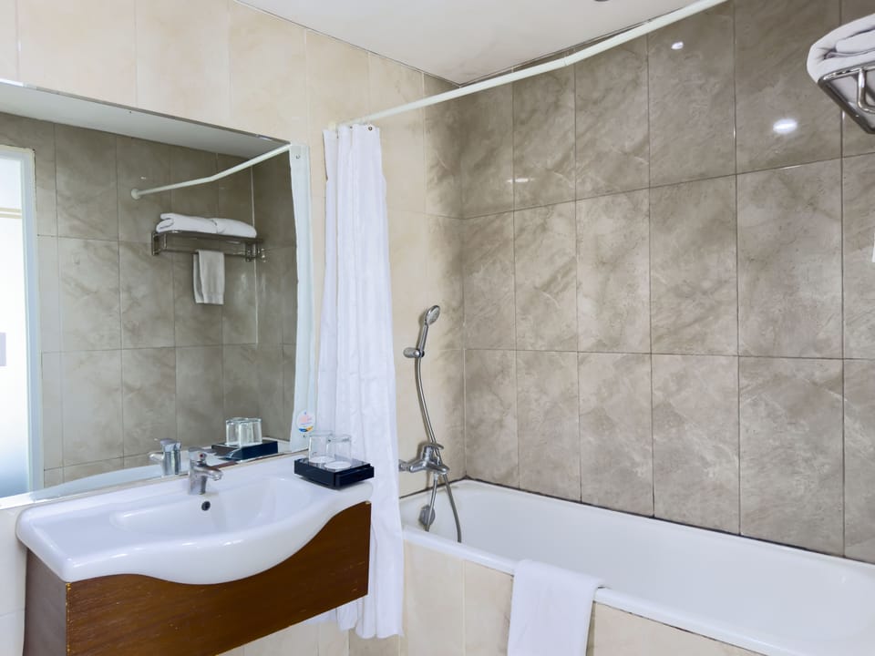 Suite, 1 Queen Bed | Bathroom | Shower, free toiletries, hair dryer (on request), slippers
