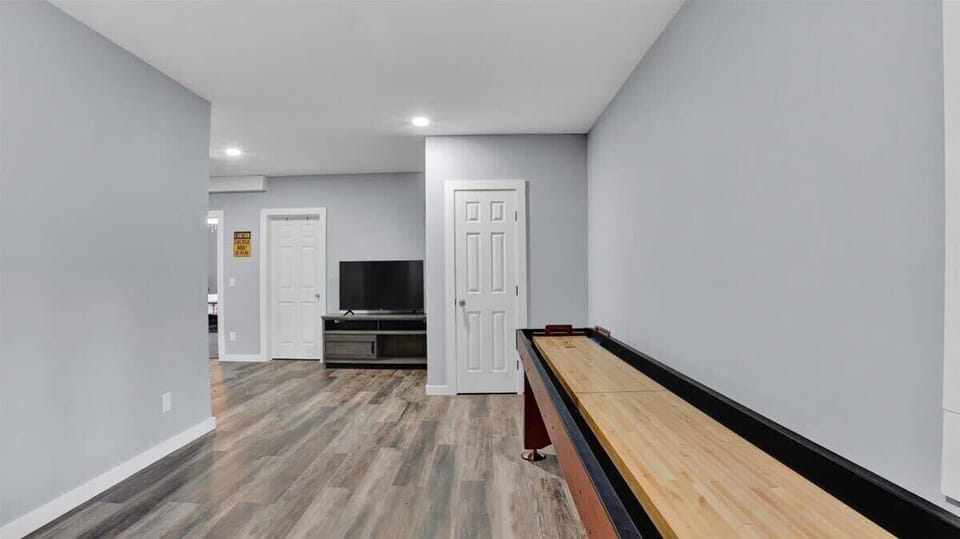 Game Room with Shuffleboard Table and Entertainment Area