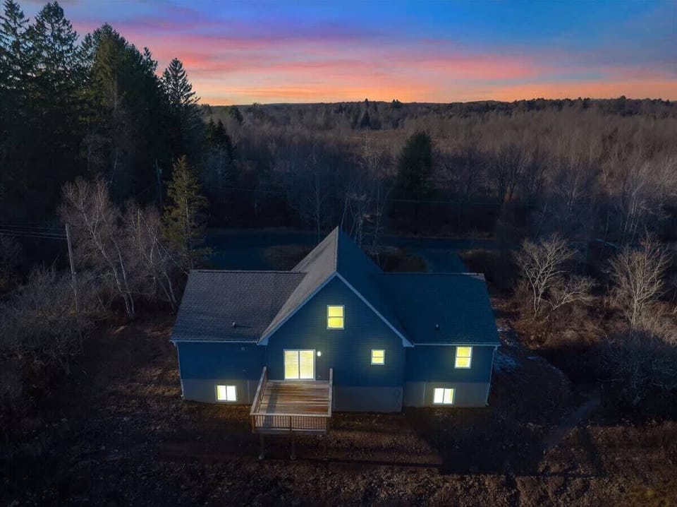 Cabin Exterior at Twilight in Peaceful Woodland Setting