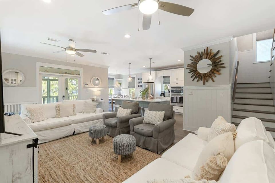 - Spacious living room with cozy seating, perfect for enjoying the views through the sliding doors - Natural light fills the room, creating a welcoming and relaxed atmosphere - Seamless flow into the kitchen & dining area, making this the ideal spot