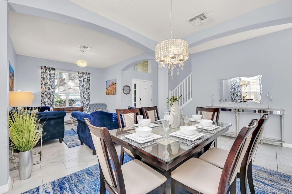 Charming Living Area of the Home in Kissimmee Florida - 6 Persons Dining - Quality materials, such as a sleek dining table and comfortable chairs - Modern Design - Intimate ambiance created through soft, ambient lighting