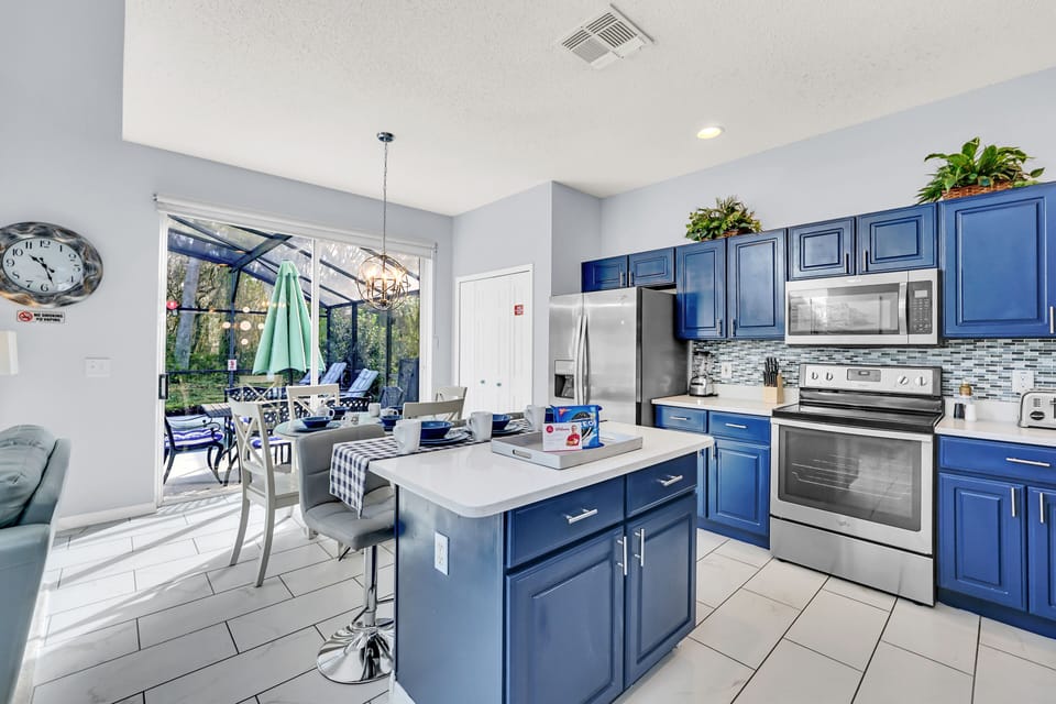 Picturesque Kitchen of the Home in Kissimmee Florida - Fully equipped kitchen - Creates a harmonious and inviting atmosphere - High Chairs and Breakfast bar