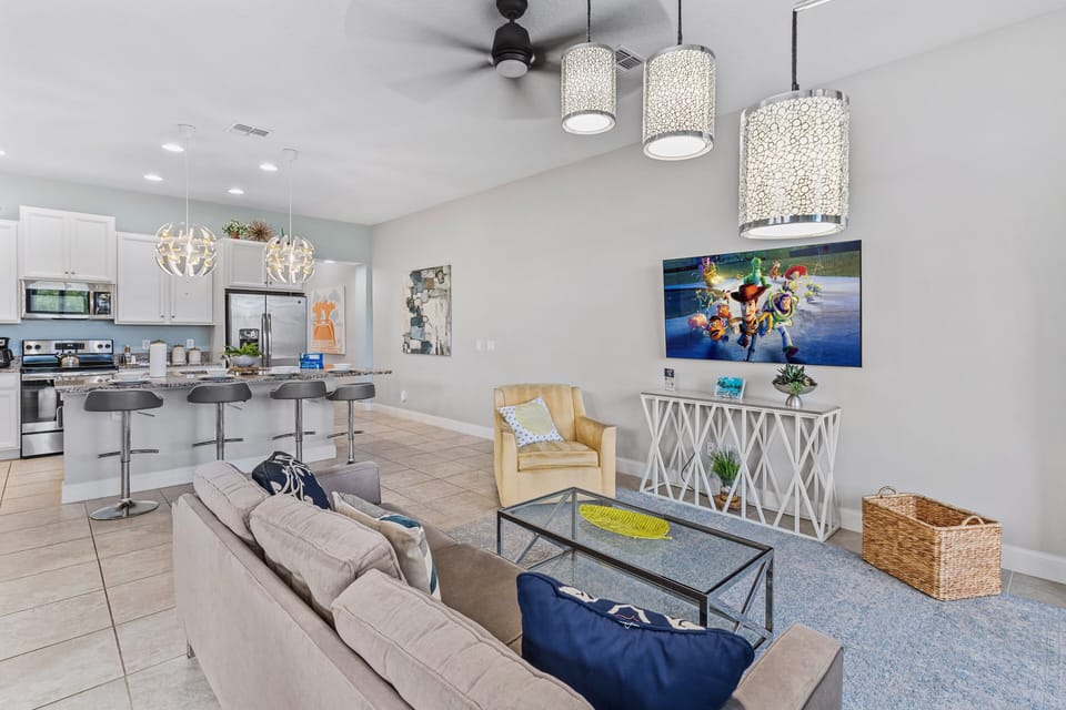 Spacious Living Area of the Townhouse in Davenport Florida - Harmonious color scheme with pops of accent colors for visual interest - Smart TV and Netflix - Cozy seating area conducive to relaxation and socializing