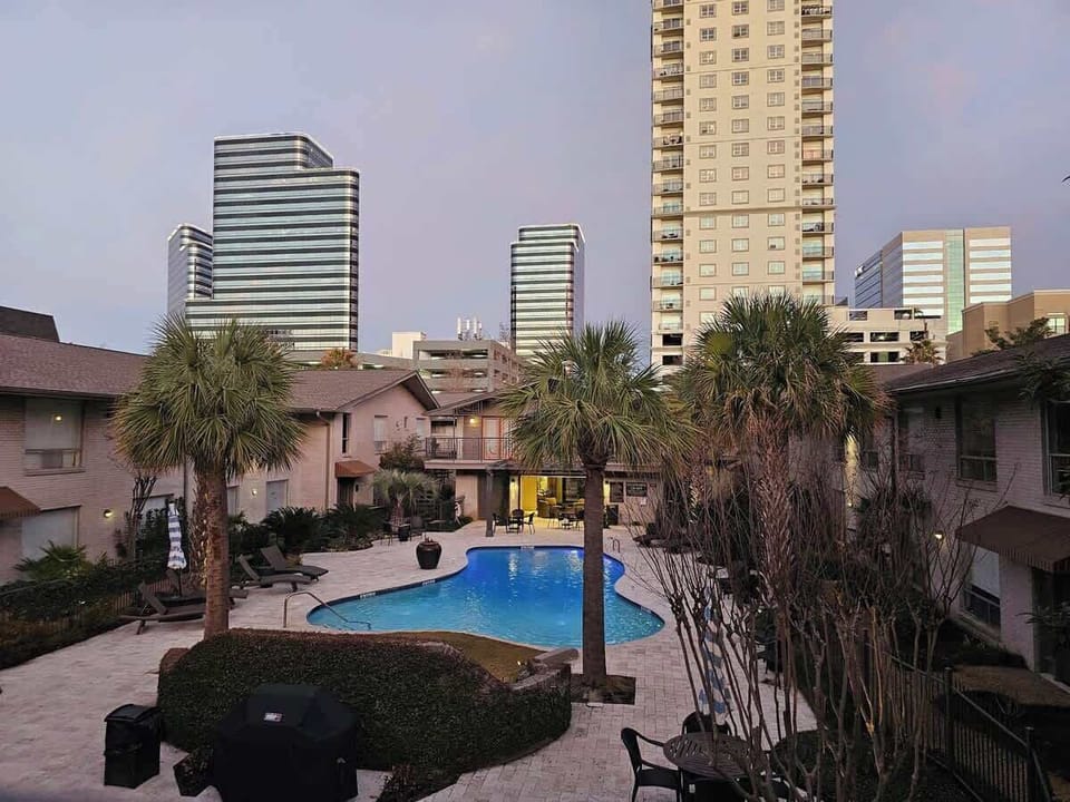 Pool:  This is the view of the saltwater pool area outside of your door.  Equipped with a propane grill and pool side gazebos and cabanas with 55 inch TV and coffee bar. 