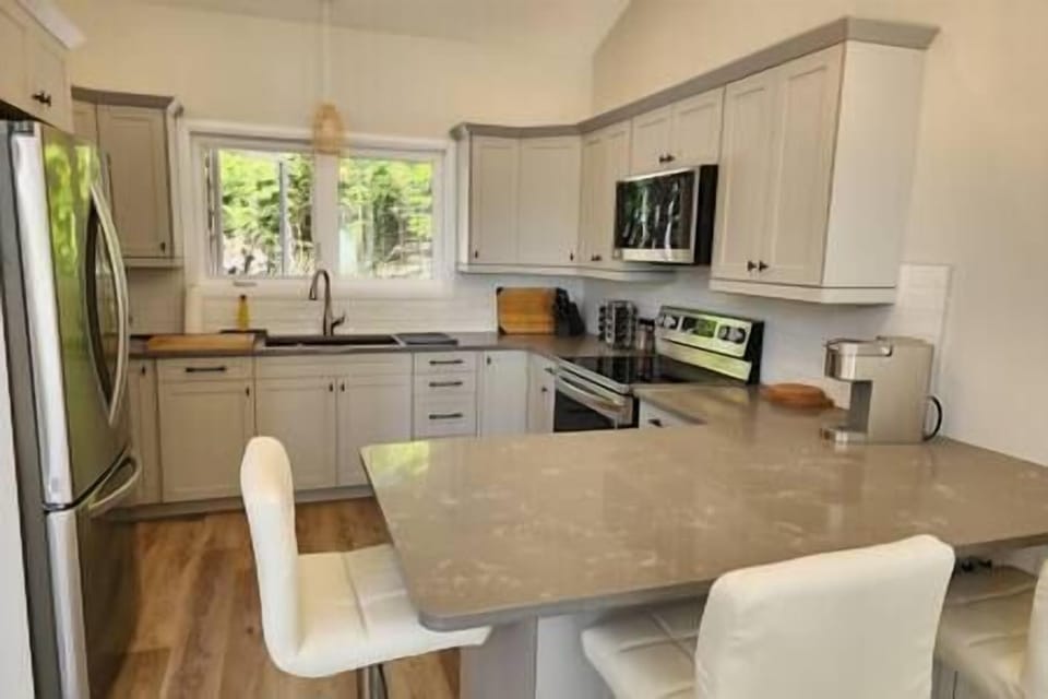 Kitchen with breakfast bar. Includes icemaker in fridge, microwave, dishwasher.