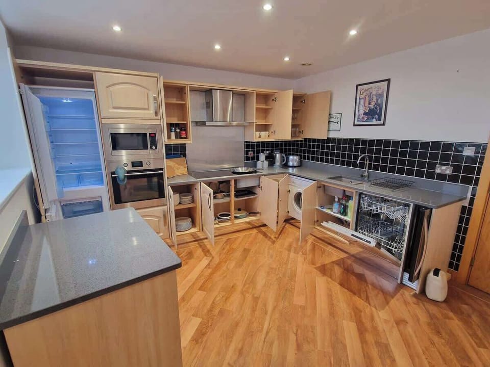 Our fully fitted kitchen includes an oven, hob, microwave, fridge freezer, wine chiller, washer dryer, dishwasher, and a complete set of kitchen utensils for your convenience.