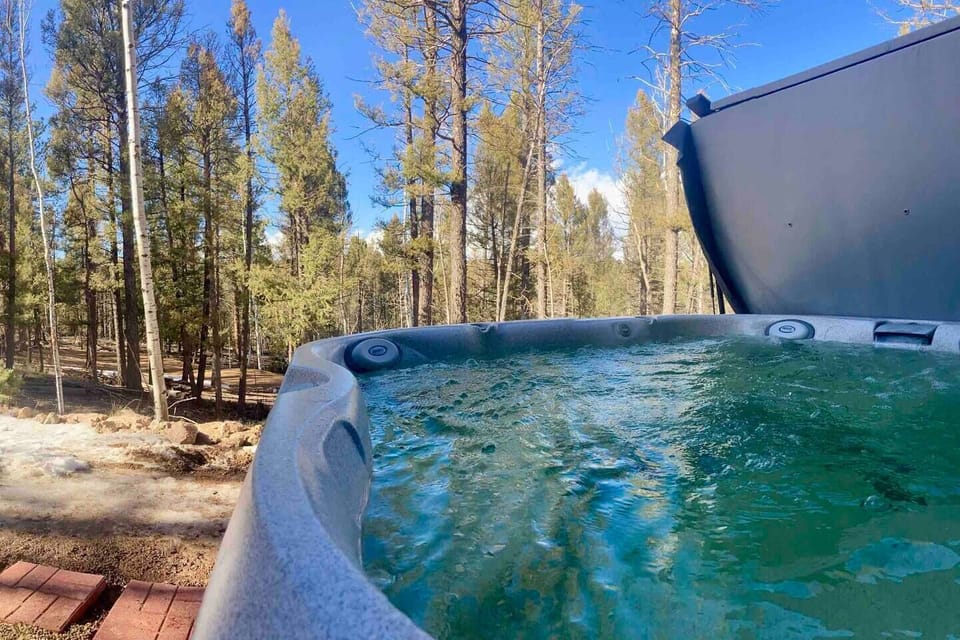 A hot tub with forest views is yours to enjoy.