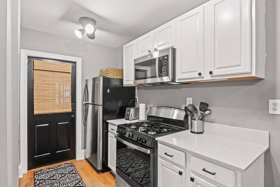 Remodeled kitchen with gas range, microwave, full size fridge and dishwasher