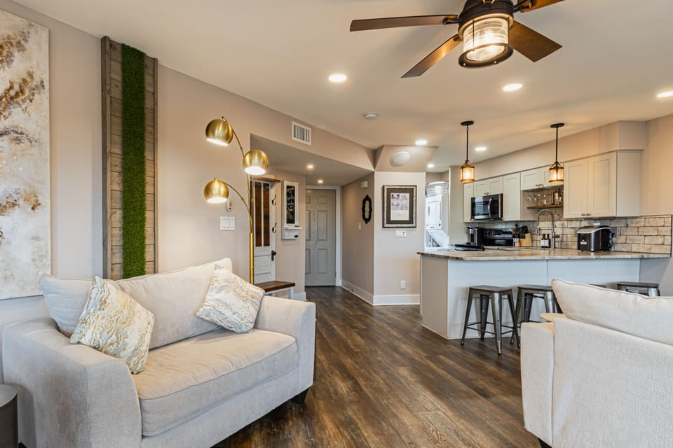 Kitchen features a counter with barstool seating.
