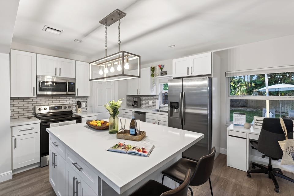 Fully equipped kitchen with barstool seating.