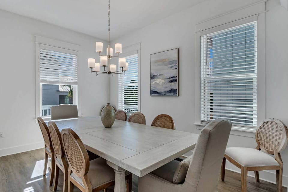 The dining area features a large farmhouse style table with comfortable seating for 8, and additional seating for 4 at the large kitchen island!