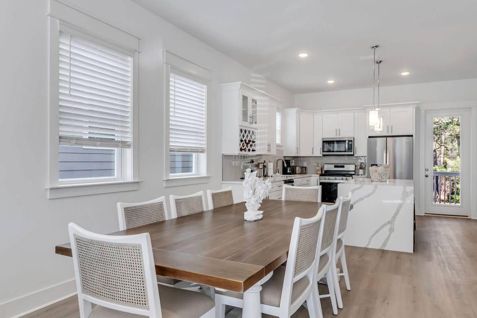 Dining table with seating for up to 8 guests, and an additional 3 seats at the kitchen island