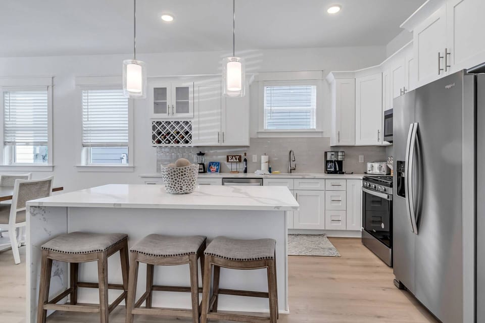 The kitchen offers beautiful quartz countertops with stainless appliances