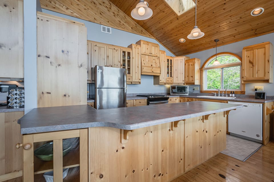 The open concept kitchen and island are within easy reach.