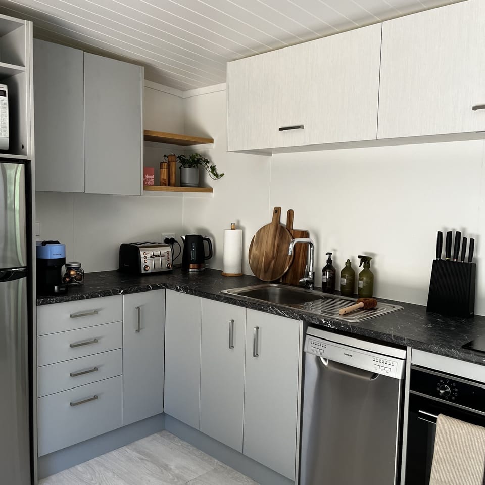 The kitchen - with oven, fridge, toaster, kettle, coffee machine, dishwasher,..