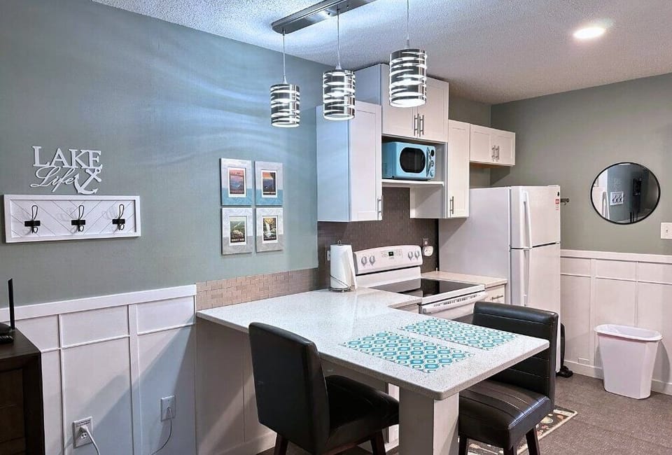 Modern Kitchenette includes essential cooking supplies such as microwave, stove/oven, coffee maker, and fridge