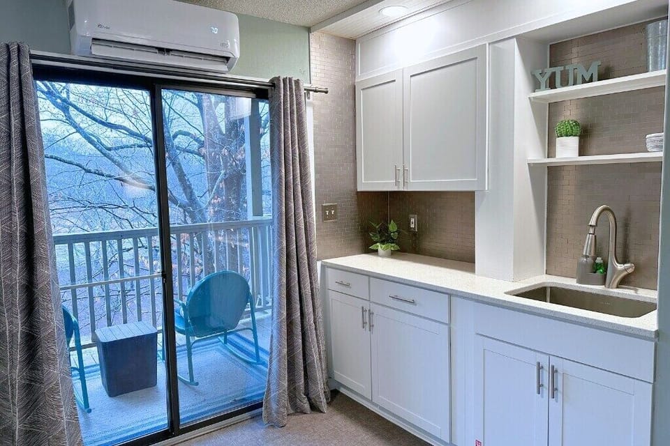beautifully decorated kitchen paired with plenty of natural light from glass doors really opens up the place!
