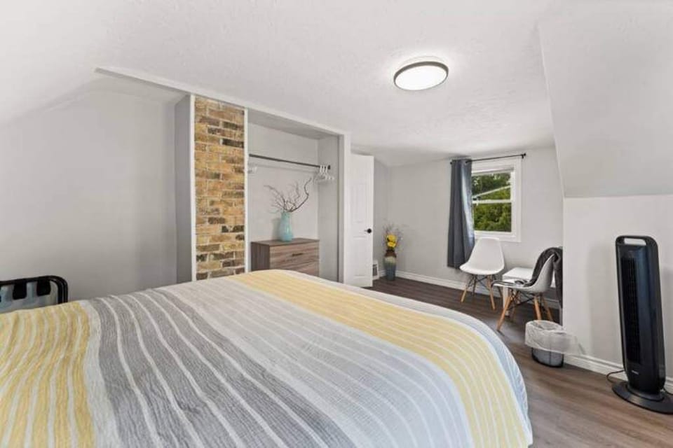 Bigger upstairs bedroom with Queen bed and seating area.