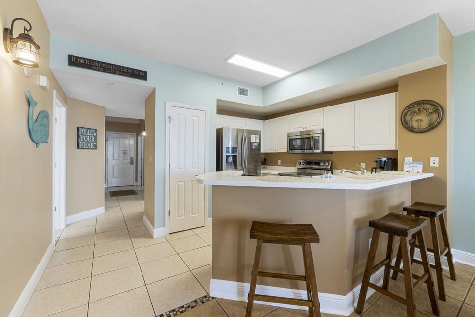 There is a dining table, perfect for enjoying a meal or playing a game, as well as additional breakfast bar seating.