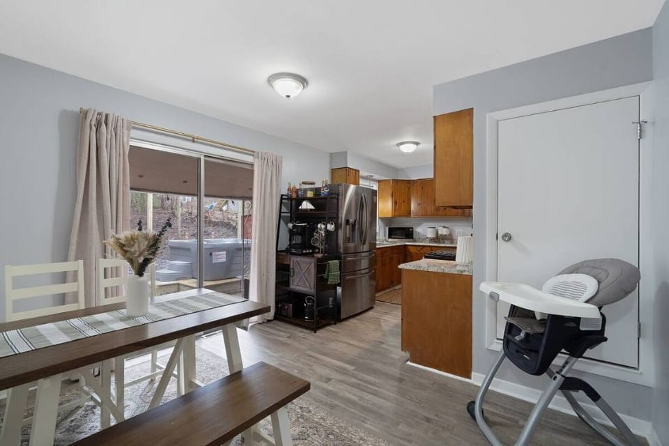 Sunny and open kitchen, with a view of the fire pit and hot tub.