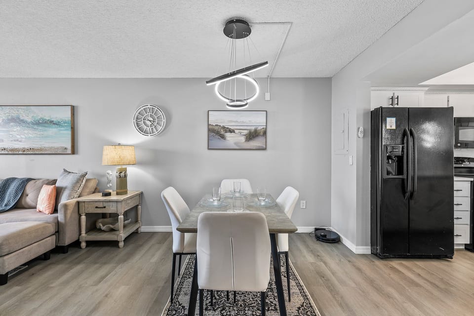 The dining area flows seamlessly into the adjacent living room and kitchen, offering an open-plan layout perfect for entertaining or casual meals.