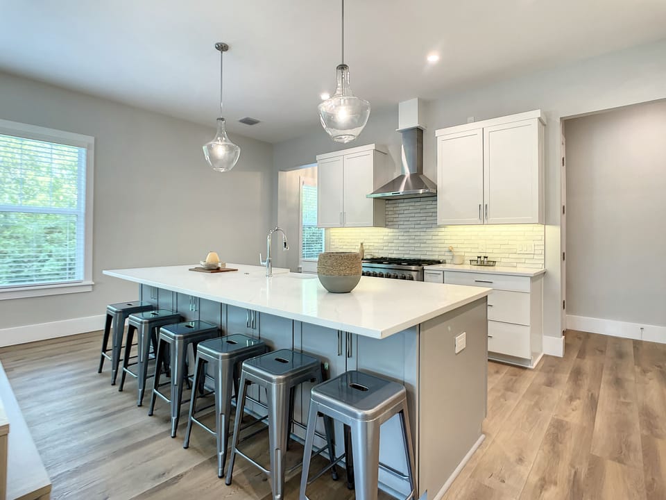 Our open kitchen with a sizable island, dining area, and breakfast bar is designed for both gourmet cooking and casual dining