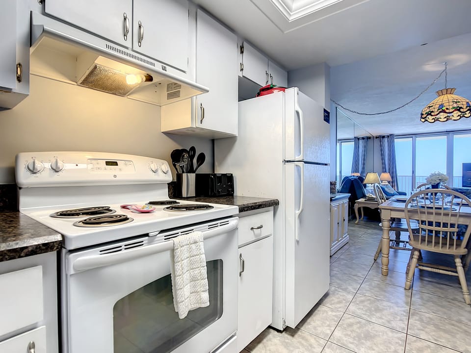 Bright, modern kitchen with essential appliances and convenient access to the dining area.