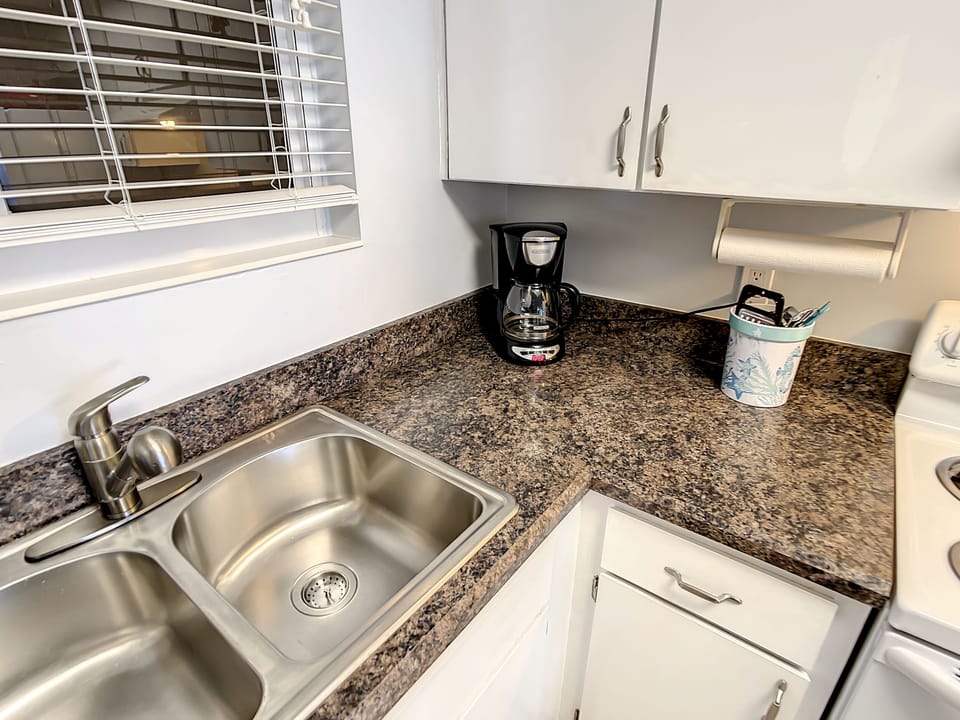 Efficient kitchen setup with modern appliances, a dual sink, and ample counter space.