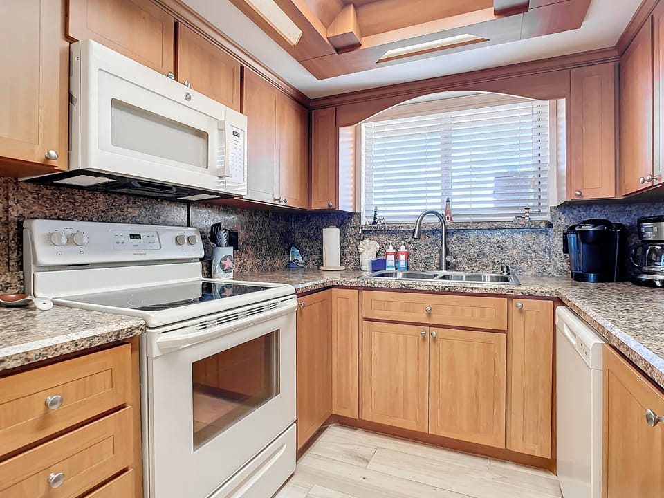 Sleek kitchen featuring stainless appliances, granite countertops, and custom cabinets. Enjoy a perfect blend of functionality and style for your cooking needs.