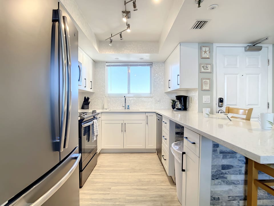 Fully equipped kitchen with modern finishes, ample storage, and a stylish backsplash.