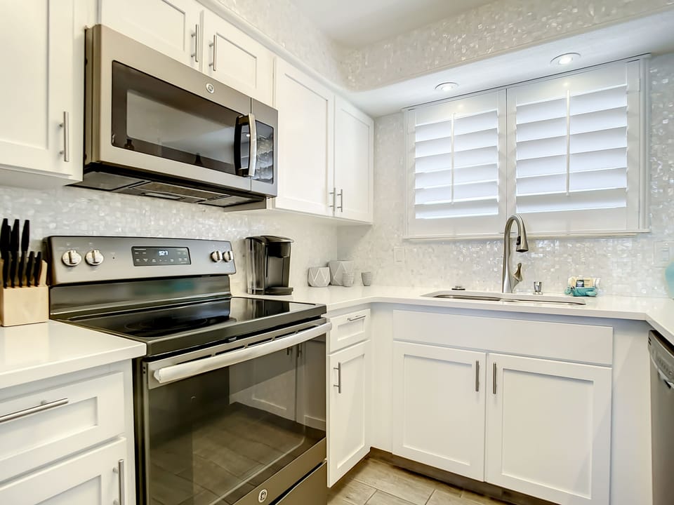 Well-lit kitchen with a spacious layout, perfect for preparing meals and enjoying the ocean-inspired decor.