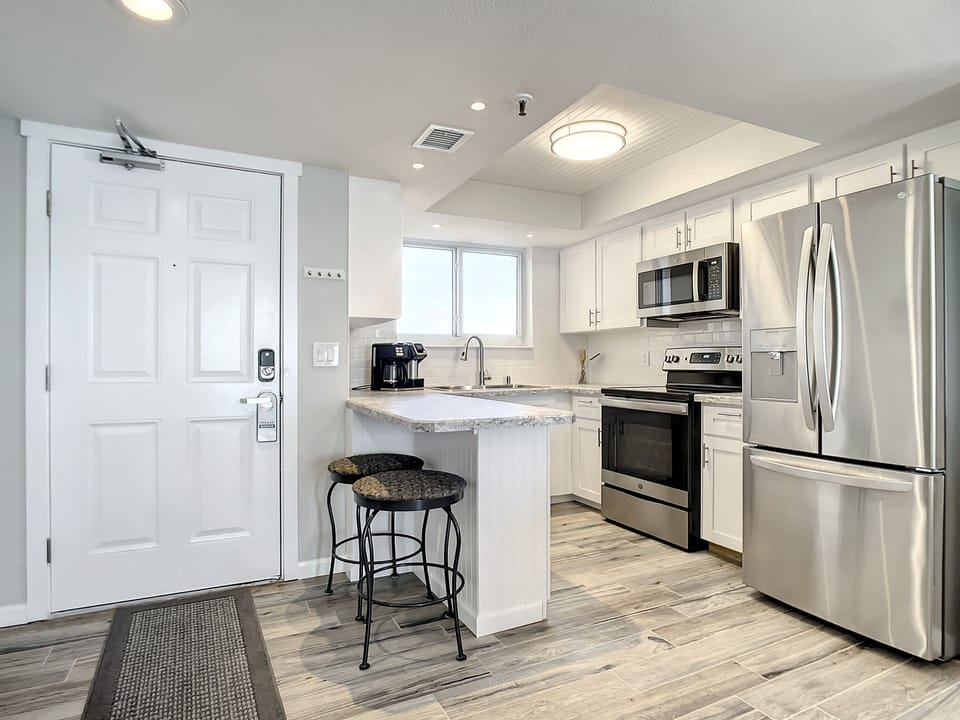 Modern kitchen featuring stainless steel appliances, ample counter space, and a convenient breakfast bar.
