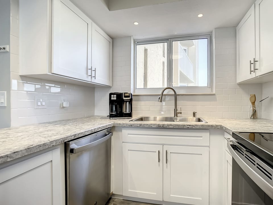 Fully equipped kitchen with stainless steel appliances and ample counter space, ideal for home cooking.