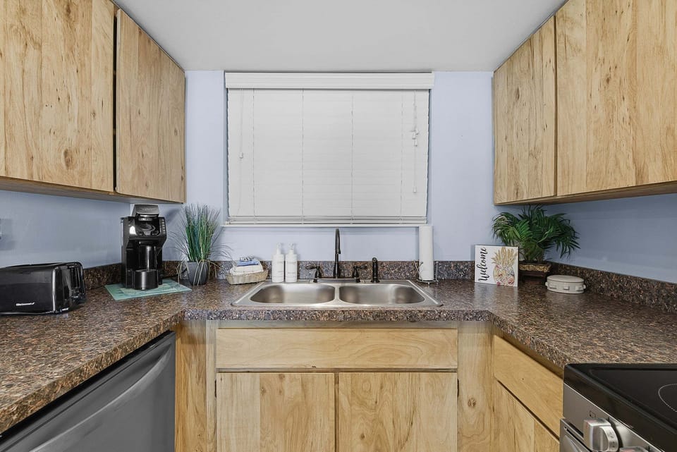 Functional kitchen with ample counter space, modern essentials, and coastal accents. Perfect for your beach stay, easily prepare meals and snacks before heading out to enjoy the sun, sand, and ocean.