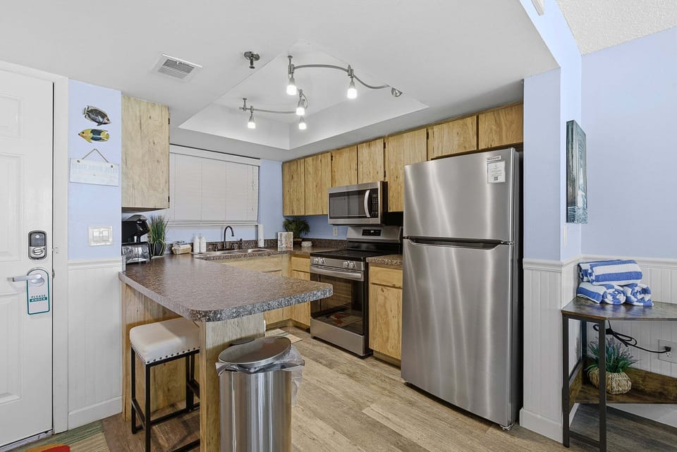 Fully equipped coastal kitchen perfect for your beach stay, featuring modern appliances, breakfast bar, and bright, airy design. Ideal for easy meals after a day enjoying the sun, sand, and ocean breeze.