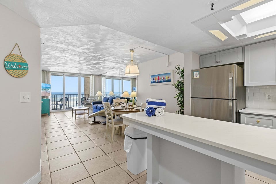 Enjoy a comfortable beach stay in this bright, open-concept condo featuring a full kitchen, dining area, and cozy living space with ocean view balcony access. Ideal for relaxing after a day on the sand.