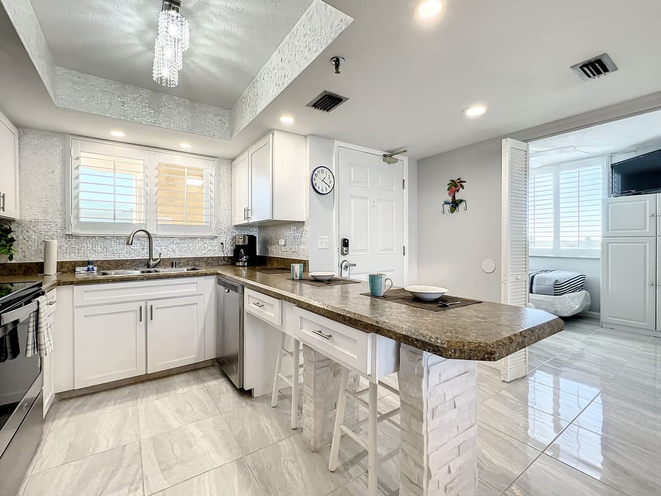 Inviting kitchen space with bar seating and natural lighting, ideal for morning coffee or quick meals.