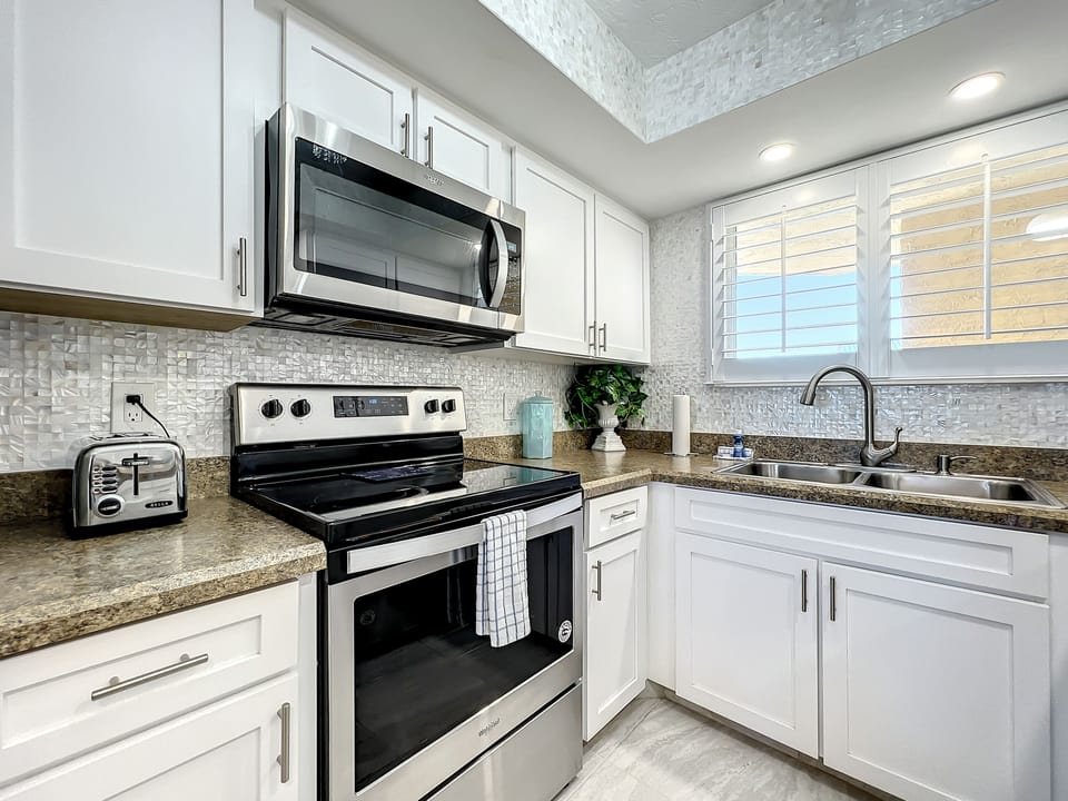 Fully equipped kitchen with stainless steel appliances, granite countertops, and stylish cabinetry for a seamless cooking experience.