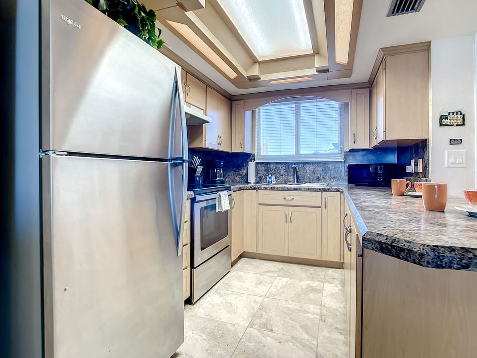 Spacious kitchen with ample counter space and natural light, ideal for preparing delicious meals.